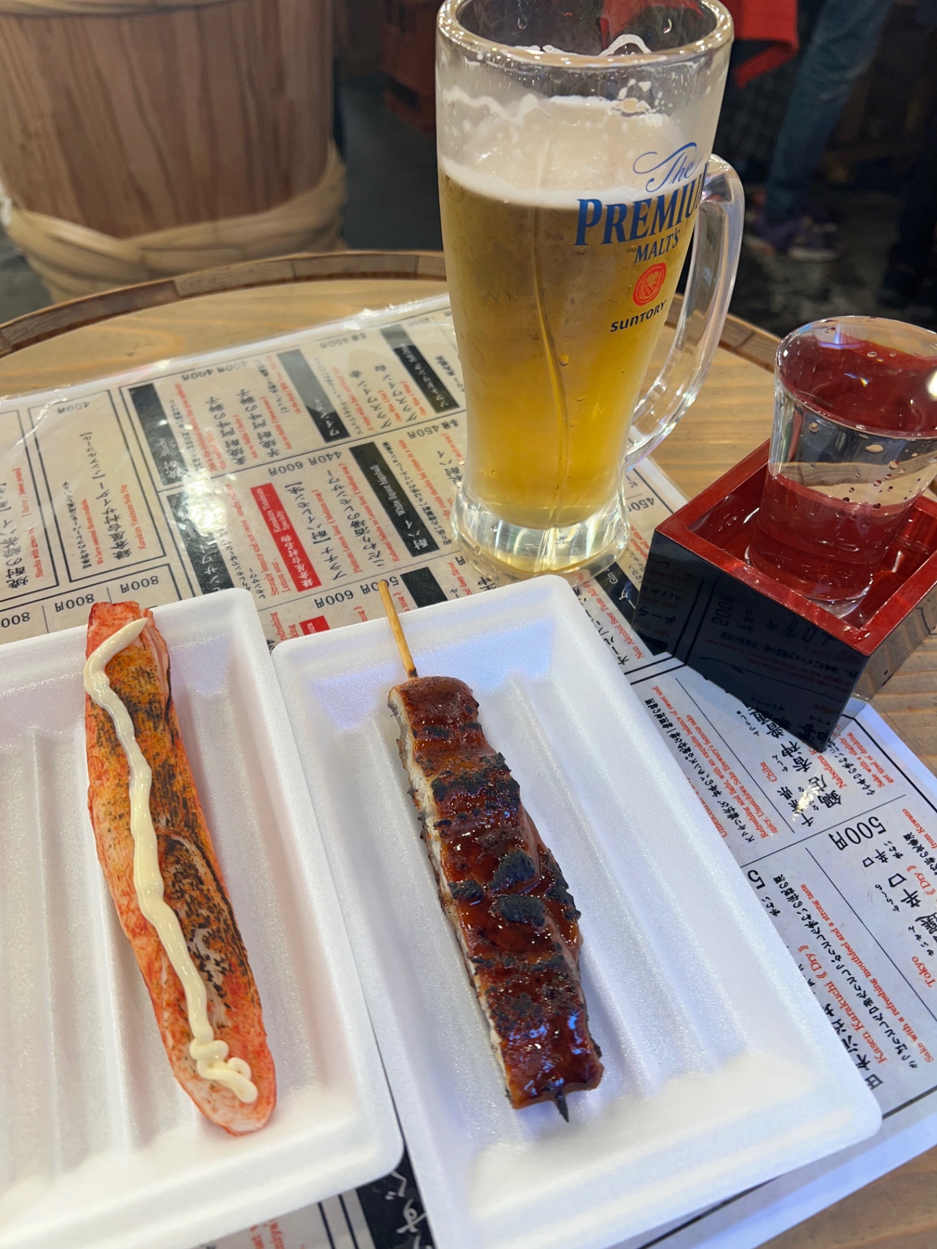 Gegrillte Yatai-Spieße mit Aal und Krebsfleisch, dazu Bier und Sake